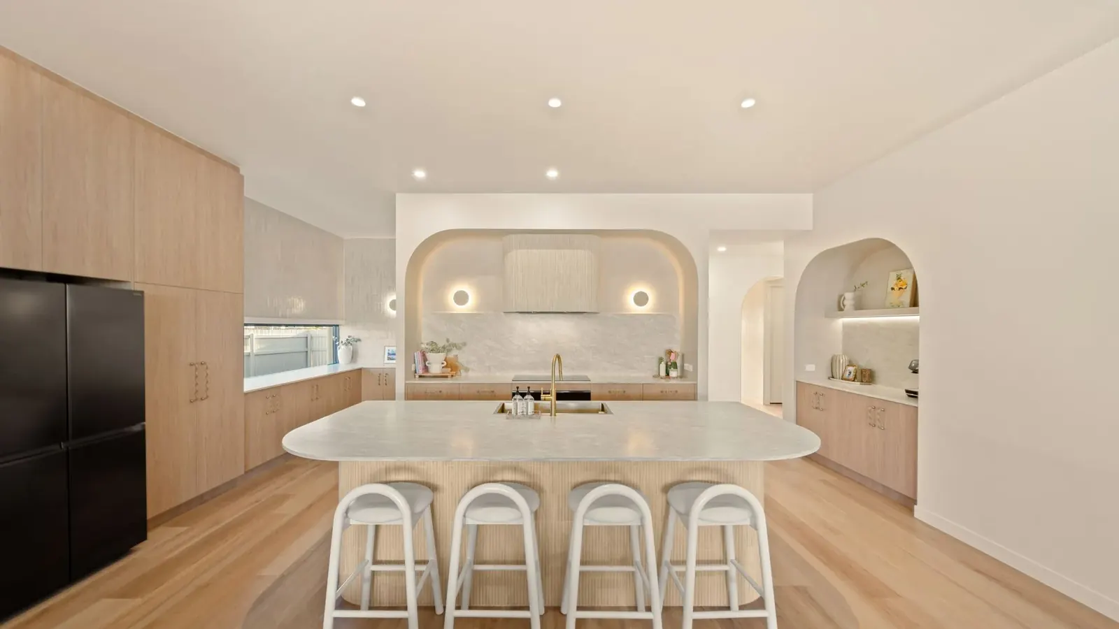 Kitchen at Sunnymount House, sculptural island and arched joinery recesses