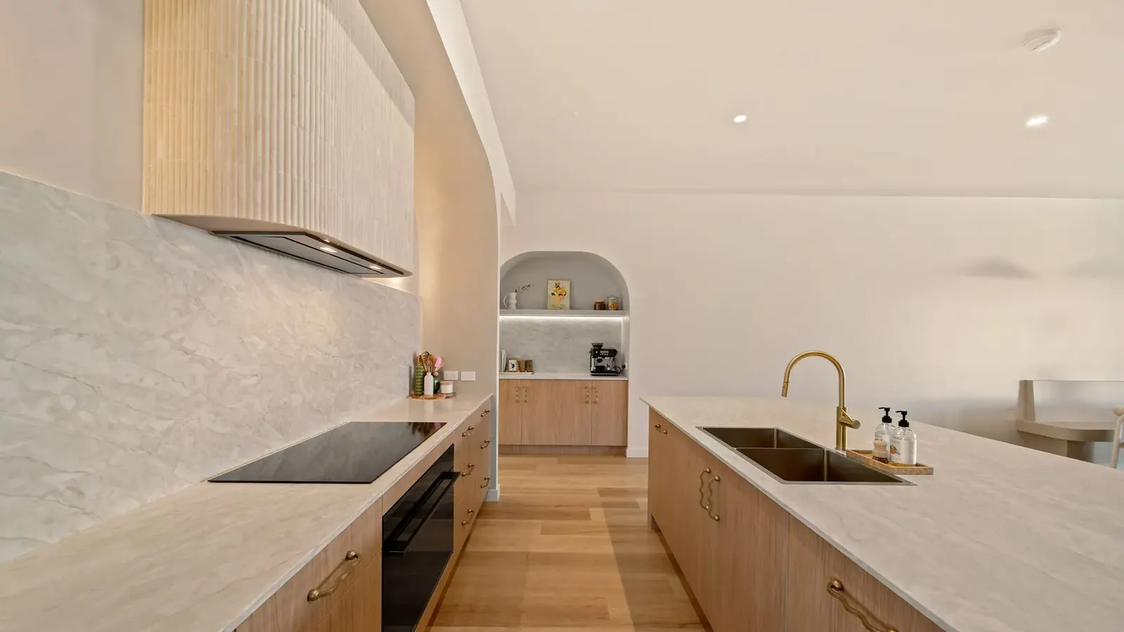 Kitchen at Sunnymount House, sculptural island and arched joinery recesses