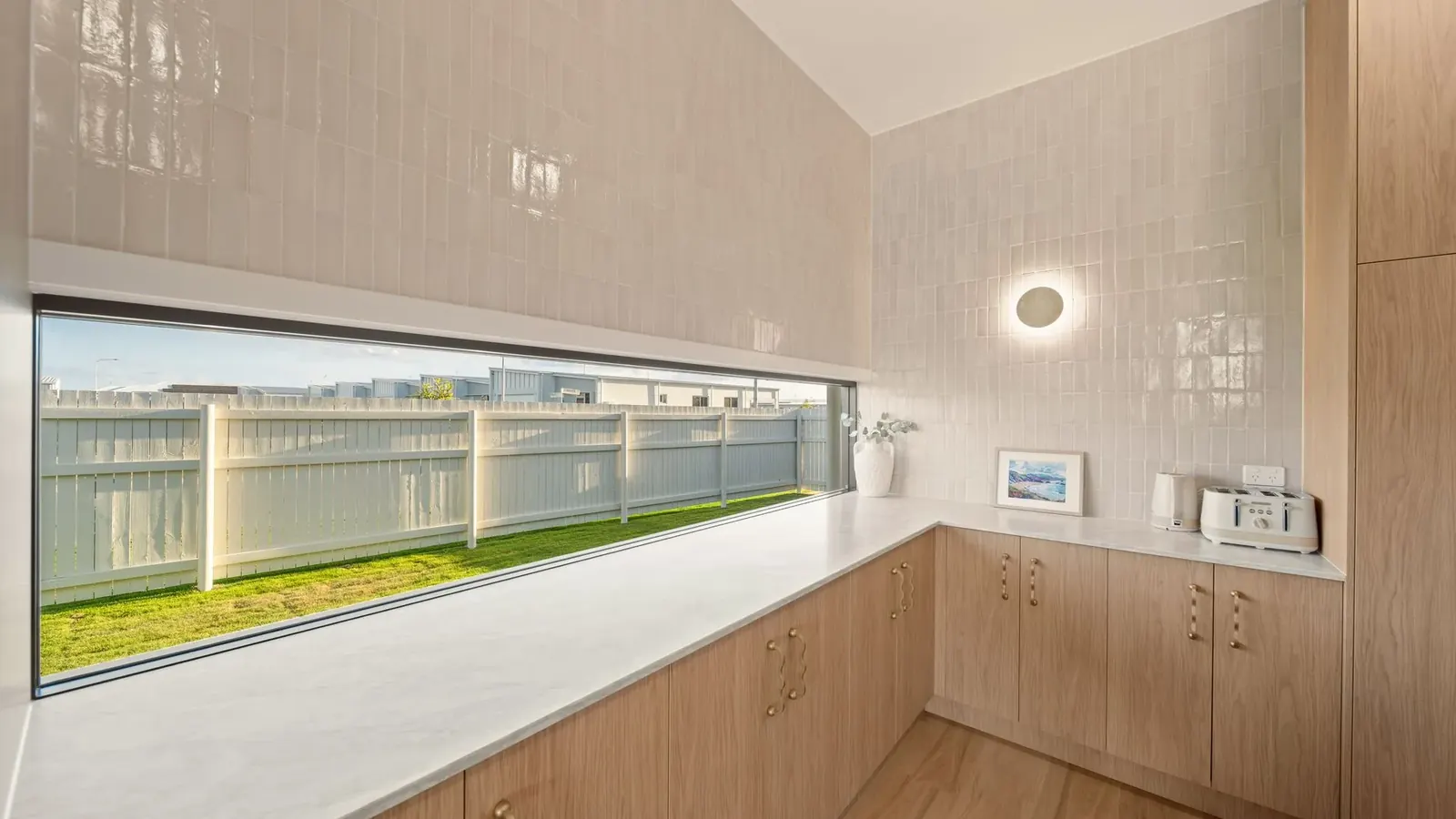 Kitchen at Sunnymount House, sculptural island and arched joinery recesses