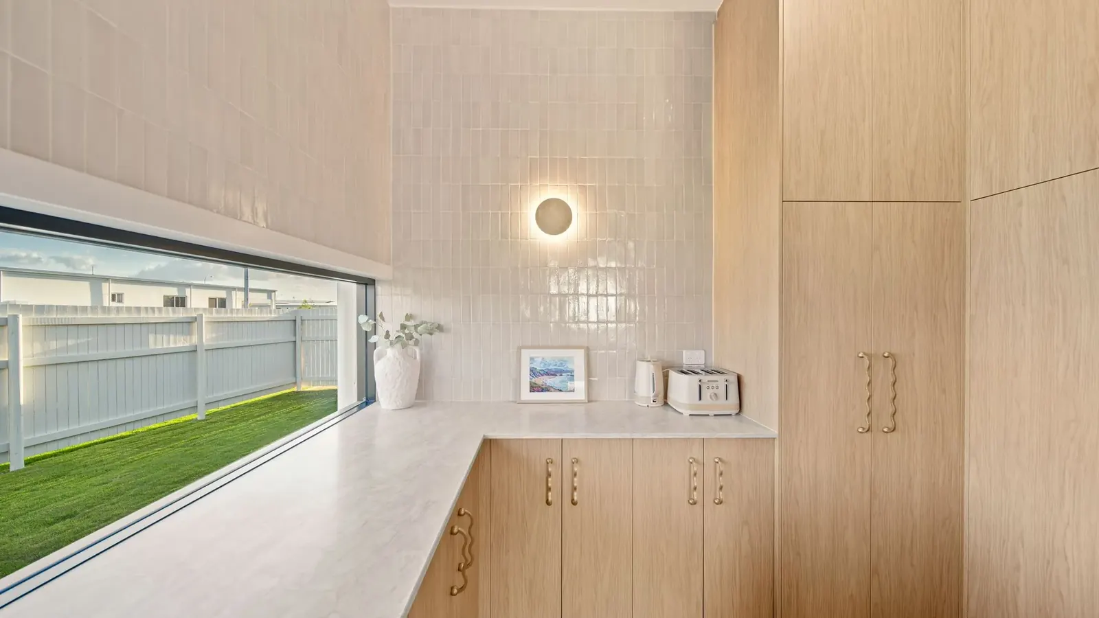 Kitchen at Sunnymount House, sculptural island and arched joinery recesses