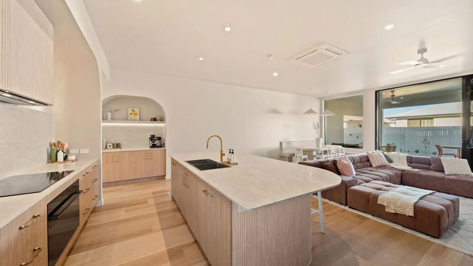 Kitchen at Sunnymount House, sculptural island and arched joinery recesses