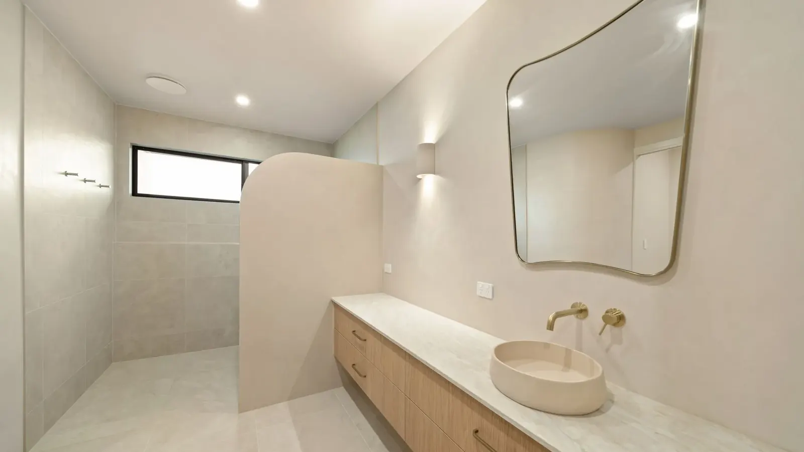 Bathrooms at Sunnymount House with stone finishes and timber vanities